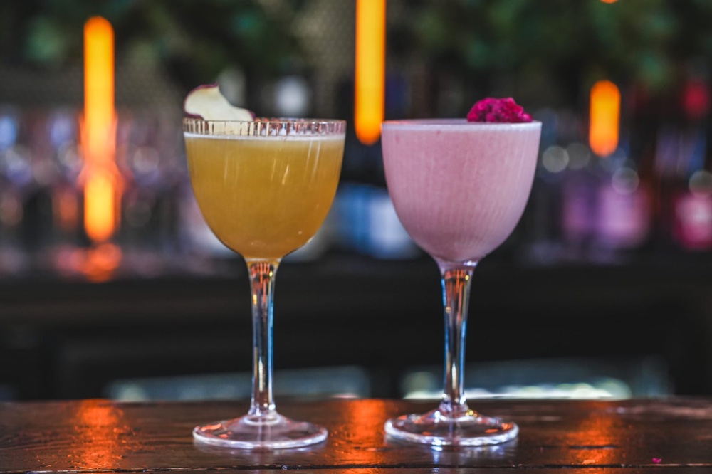 Orange and pink cocktail on bar